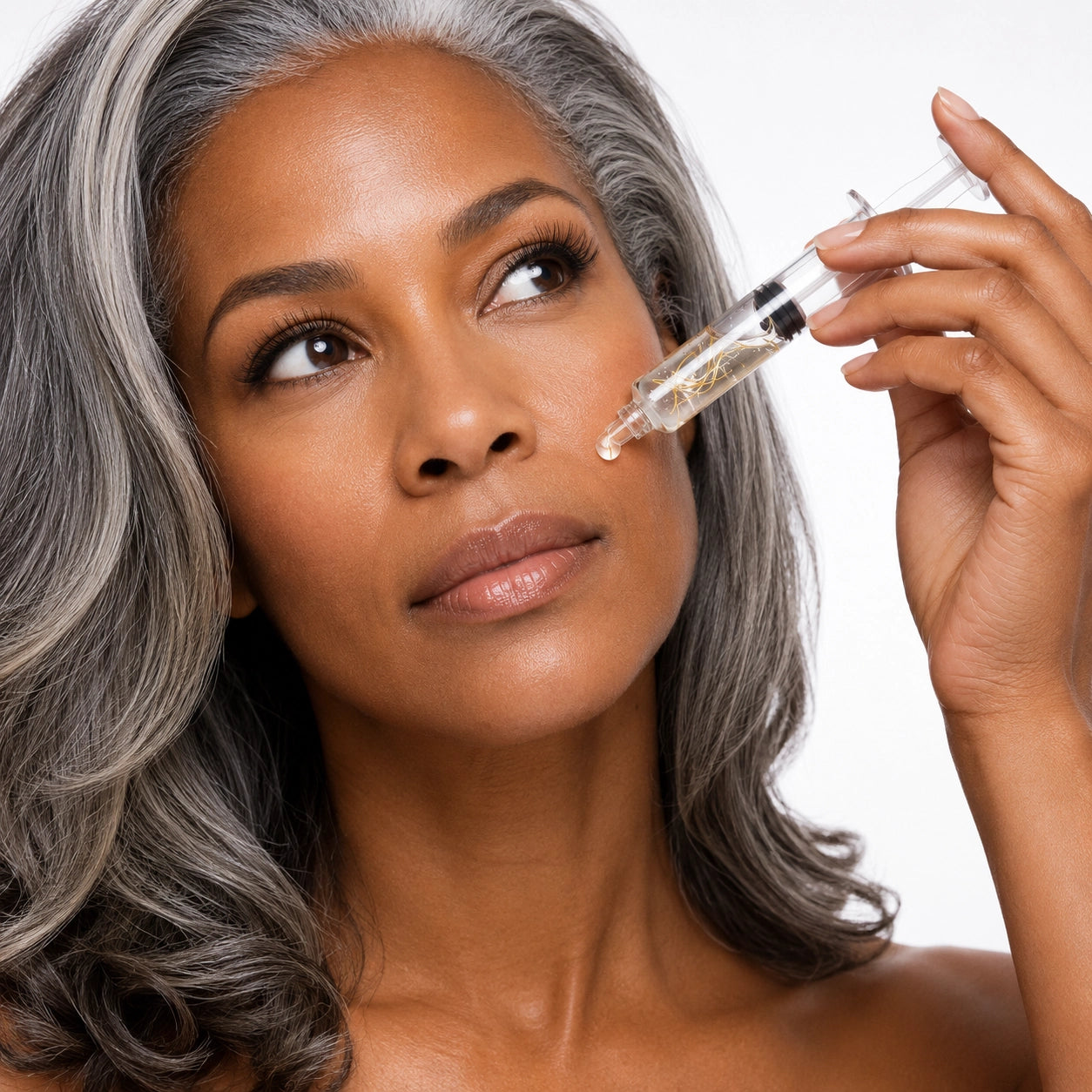 Woman applying Collagen Silk Ampoule