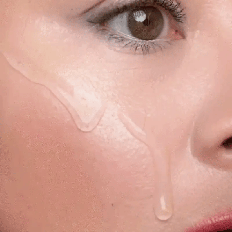 KST silk peptide threads on a fingertip, melting into skin