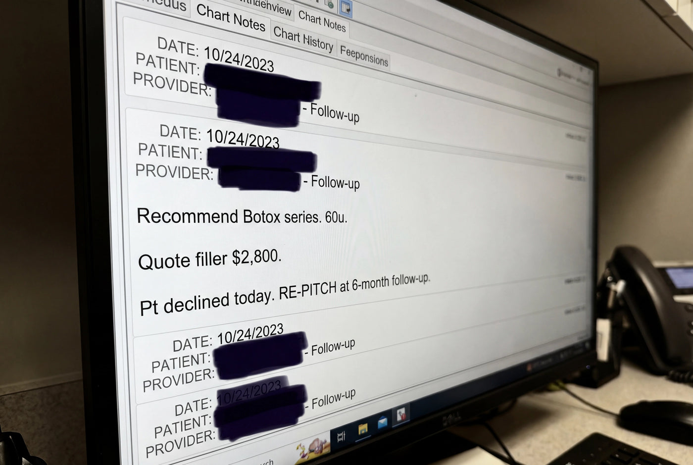 Doctor typing into an iPad at a clinic workstation