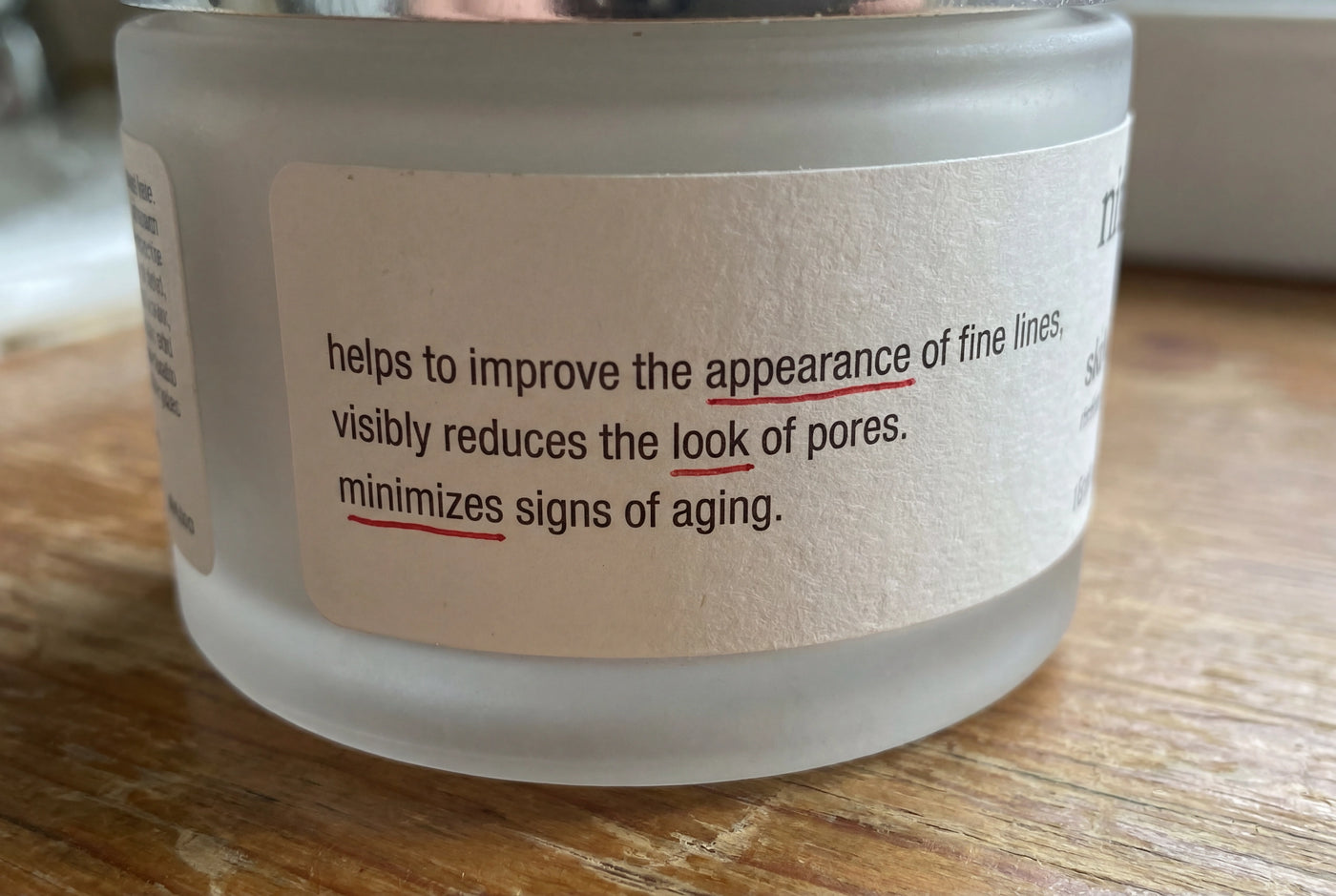Close-up of fine print on the back of a luxury skincare jar